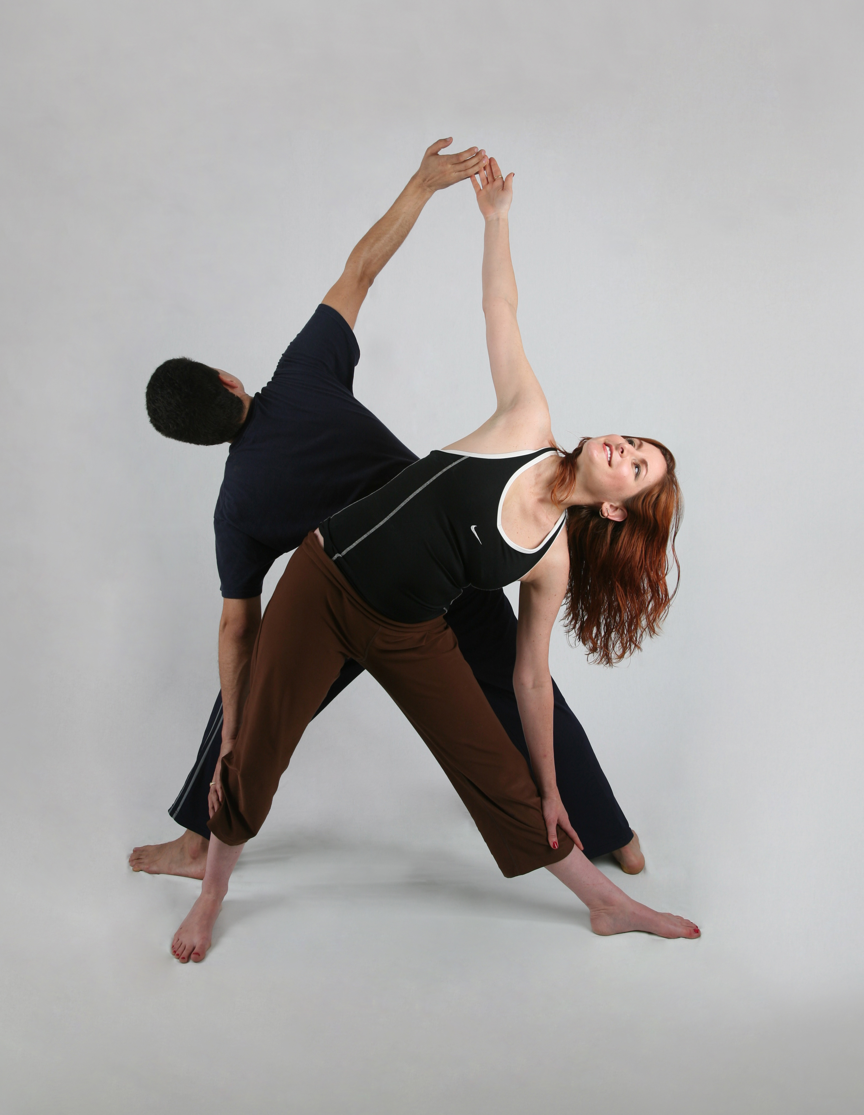 Premium Photo | Young couple practicing acro yoga on mat in studio together  acroyoga couple yoga partner yoga